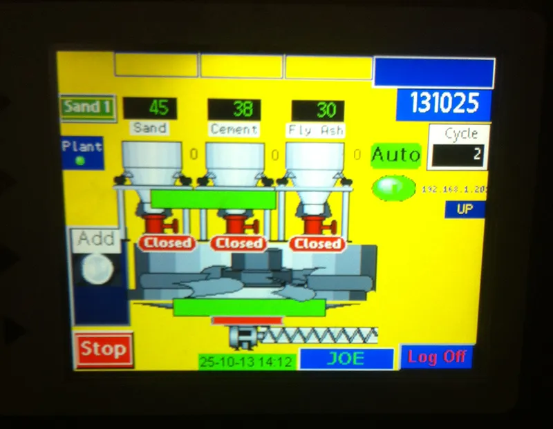 A touchscreen showing a batch plant with sand, cement and fly ash hoppers above a mixer
