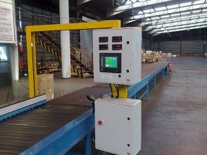 A yellow dimensioning gantry and control panel over a roller conveyor